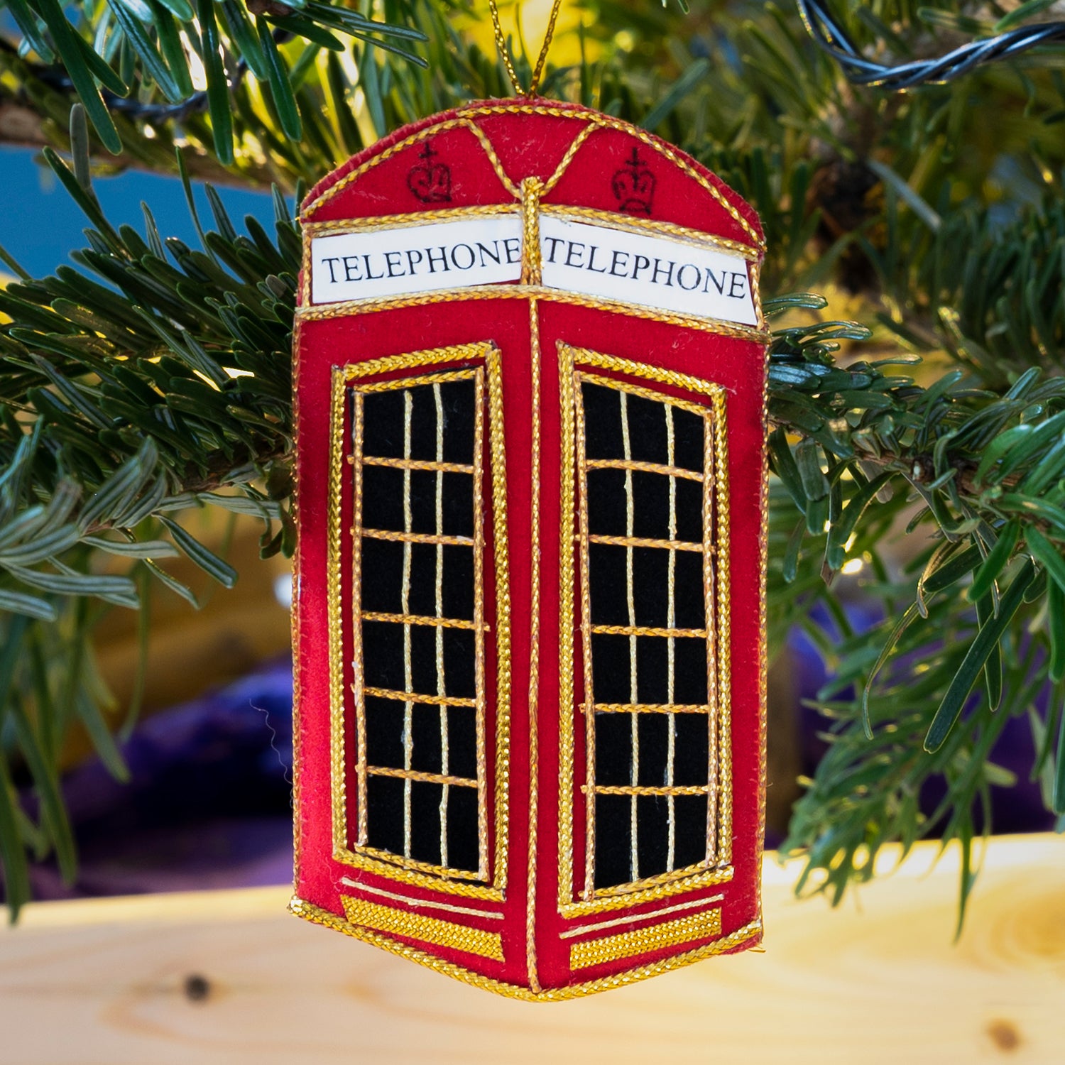 Stitched phonebox decoration hanging from Christmas tree