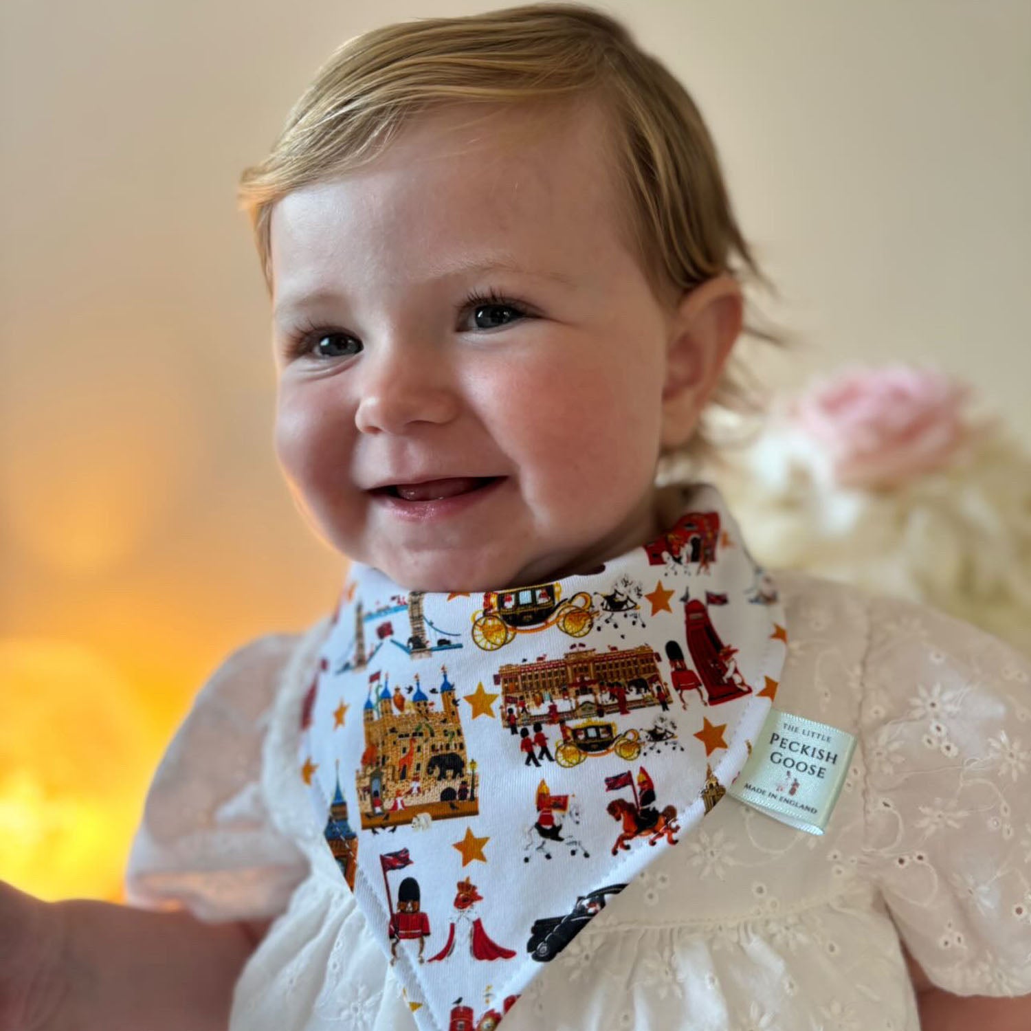 Smiling baby wearing Peckish Goose London Organic Baby Bib